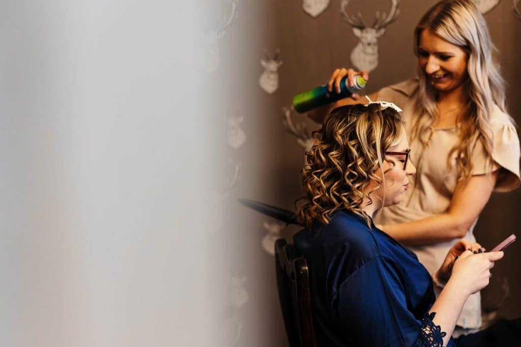 Beautiful bride with curled hair getting ready for her wedding at BGS Weddings, showcasing professional bridal hair and makeup services in the UK.