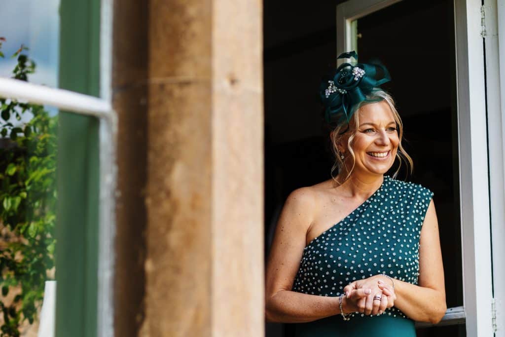 Elegant bride preparing for her wedding at BGS Weddings, showcasing a stunning dress and intricate headpiece in a beautiful countryside setting, perfect for memorable wedding celebrations.