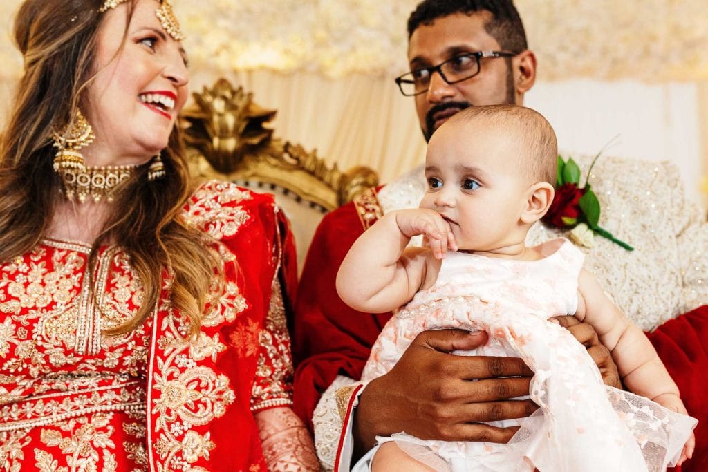 Elegant Indian wedding family portrait showcasing traditional attire, vibrant colours, and joyful expressions, perfect for wedding photography and celebration memories.