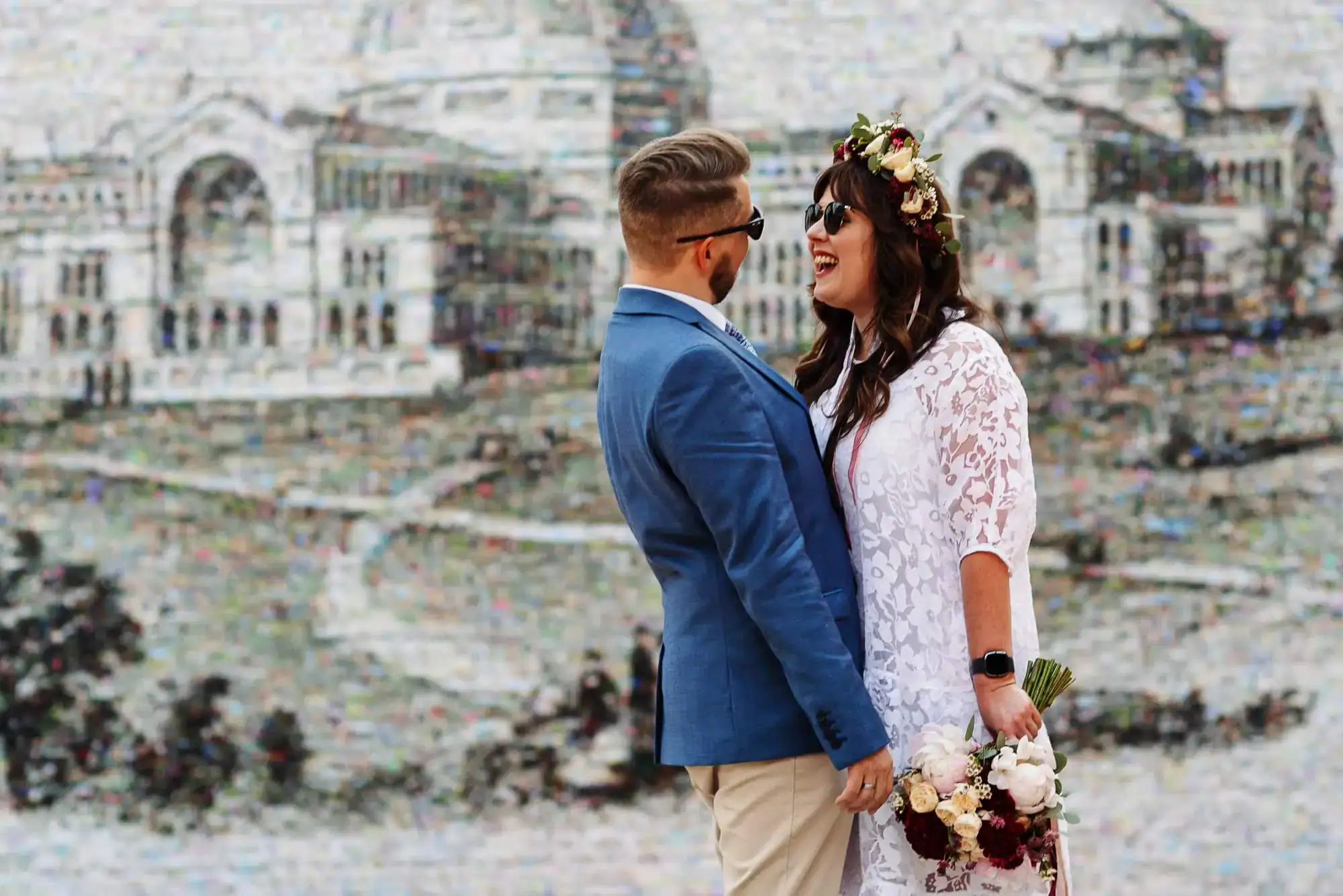 Ceremonial wedding couple embracing with cityscape background, stylish bride and groom outdoor wedding, modern wedding photography, BGS Weddings UK.
