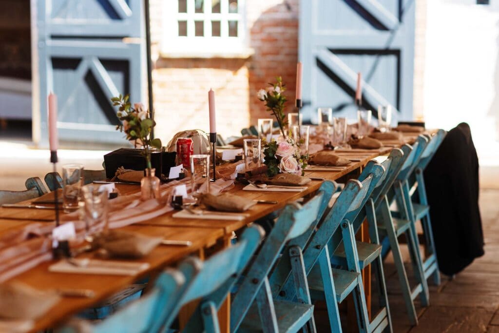 Elegant wedding reception table setup with floral centrepieces, candles, and rustic decor for a memorable wedding day. Perfect for wedding venues and celebrations.