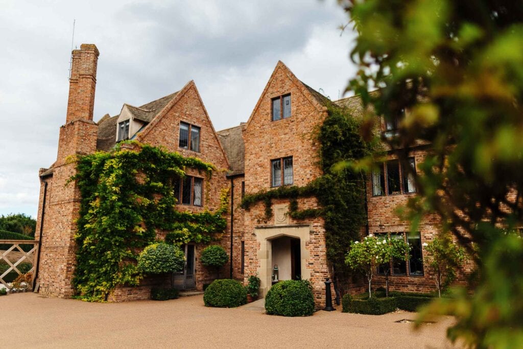 Luxurious brick wedding venue with lush greenery, perfect for romantic Dorset wedding ceremonies and receptions. Elegant and historic castle-style setting for memorable weddings.