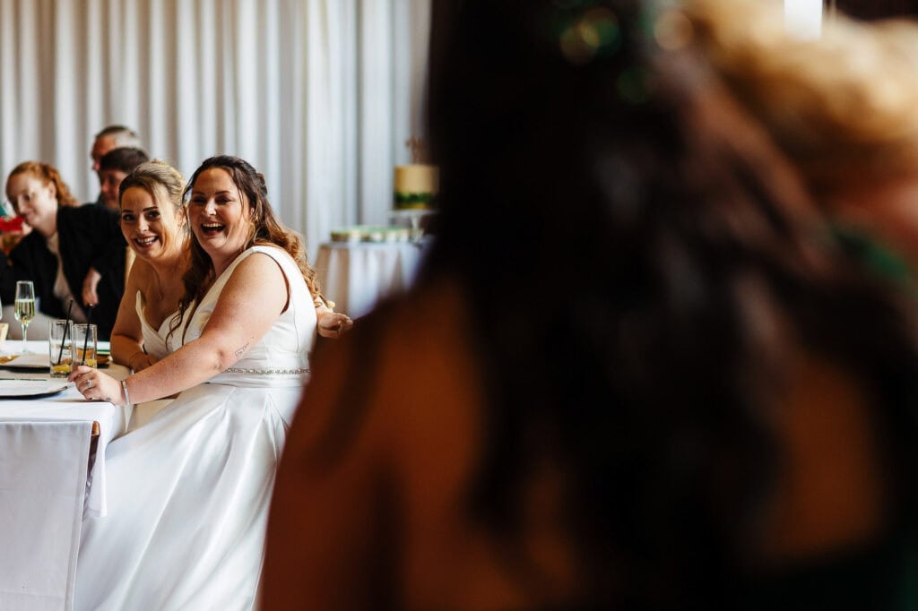 Elegant bride and guests enjoying a wedding reception at BGS Weddings venue, capturing joyful moments at a sophisticated wedding celebration.