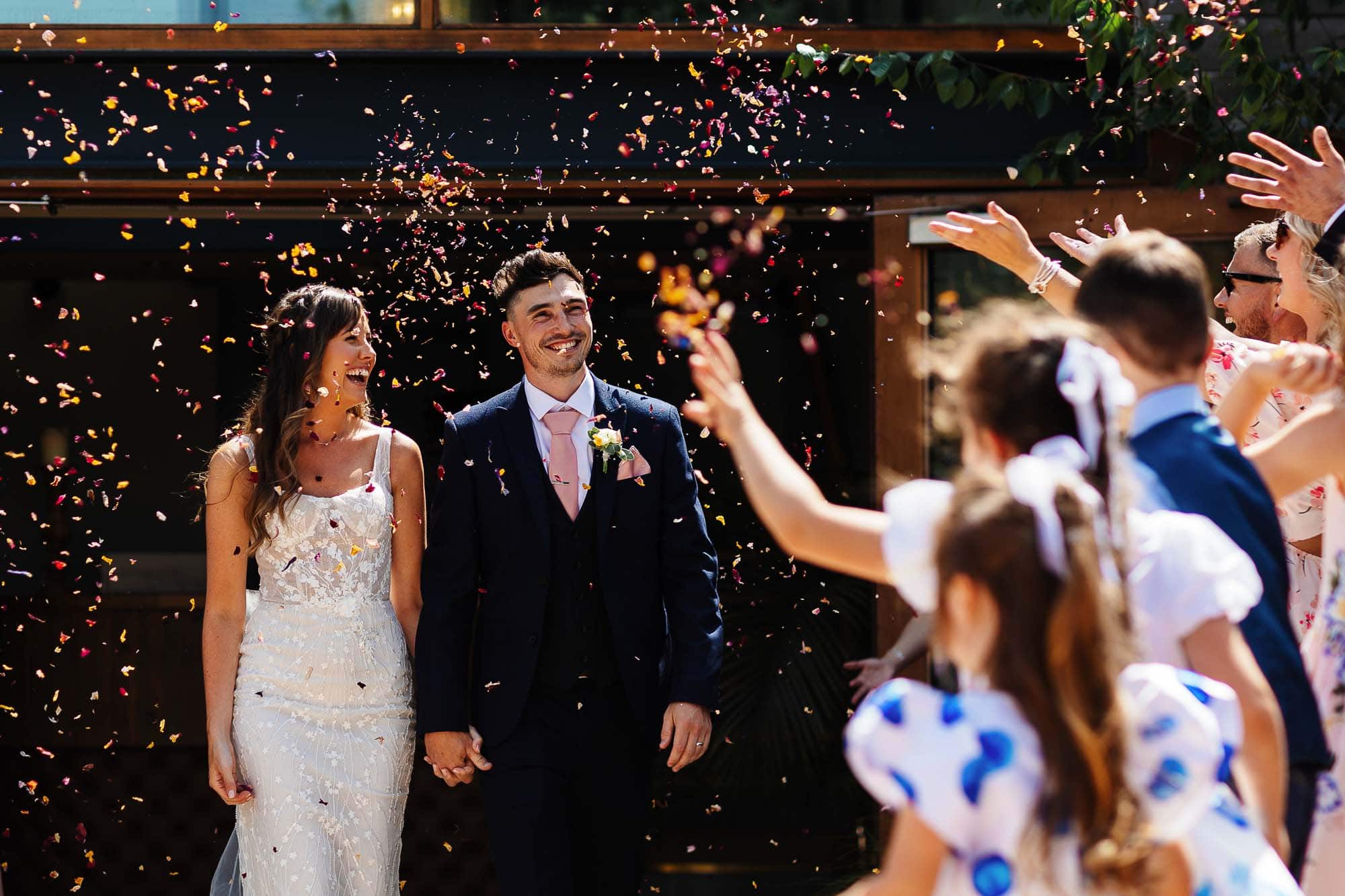 carriage hall wedding photographer Confetti throwing wedding couple outdoor celebration BGS Weddings.
