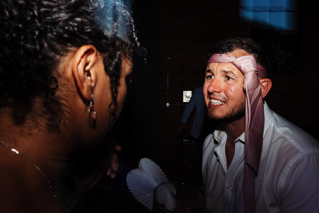 Friendly wedding guests enjoying fun moments at BGS Weddings event in UK, capturing lively celebrations and joyful interactions at the wedding reception.