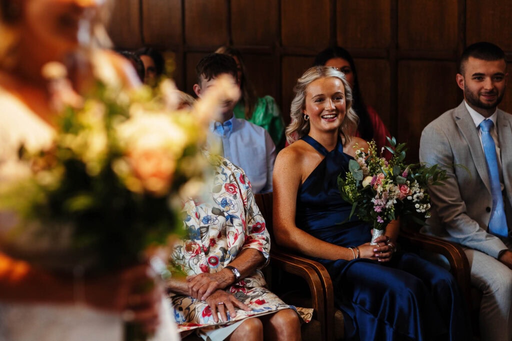 Beautiful wedding guests enjoying a heartfelt ceremony at BGS Weddings, capturing joyful moments, floral arrangements, and elegant attire for unforgettable wedding memories in the UK.