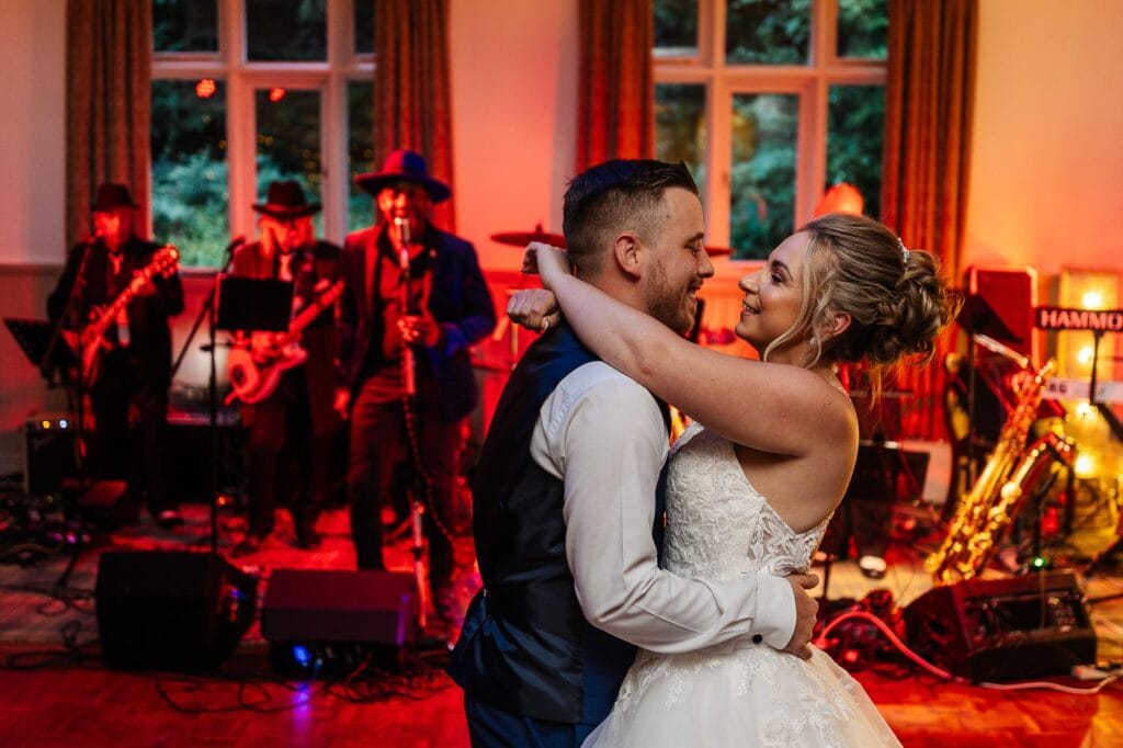 Vow renewal couple dancing at their wedding reception with live band performance in the background, showcasing romantic wedding celebrations hosted at BGS Weddings venue.