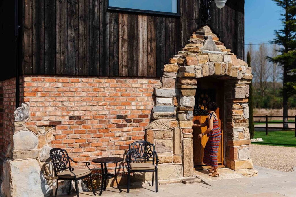 Rustic brick and stone wedding venue entrance with outdoor seating at BGS Weddings, perfect for romantic and elegant wedding celebrations in the UK.