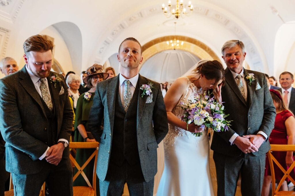 Beautiful wedding scene with bride and groom surrounded by family and friends during a heartfelt ceremony.