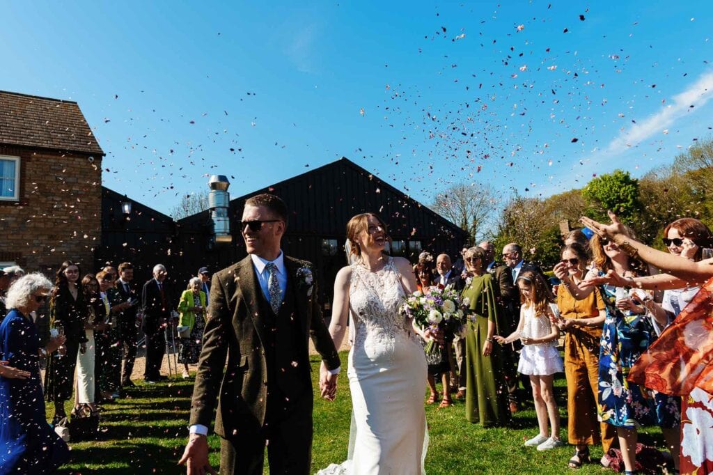 Wedding celebration with confetti and guests outdoors at BGS Weddings.