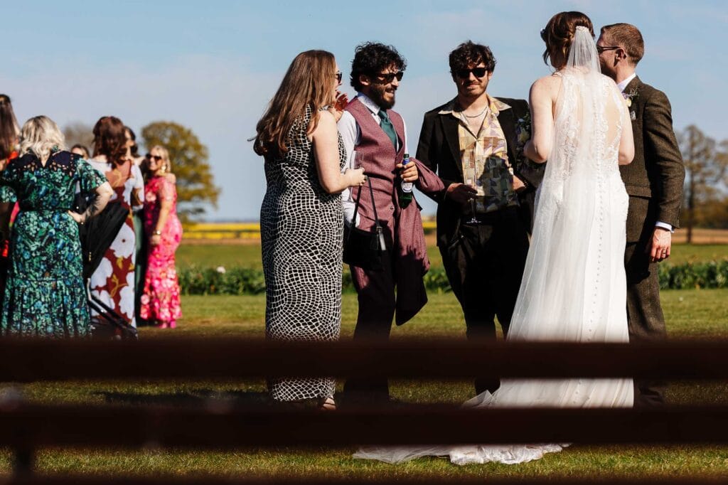 Wedding ceremony outdoors with guests and bride and groom.