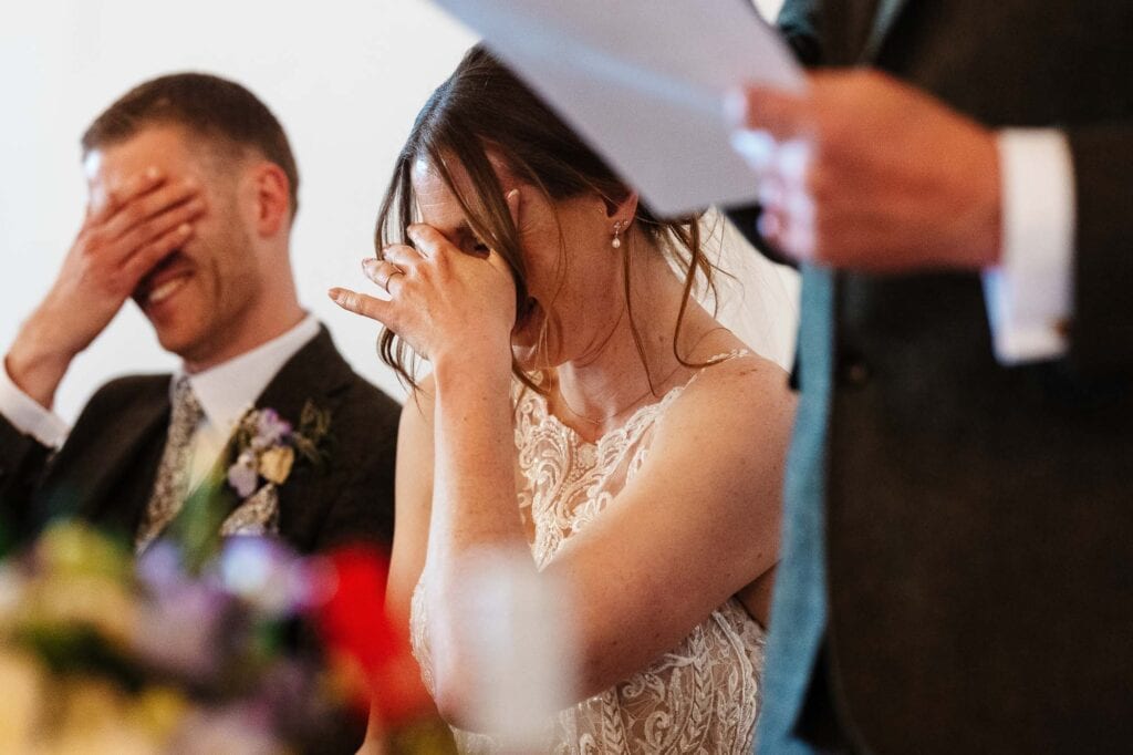 A bride and groom share a heartfelt moment during their wedding ceremony, capturing the joy and emotion of the special day.