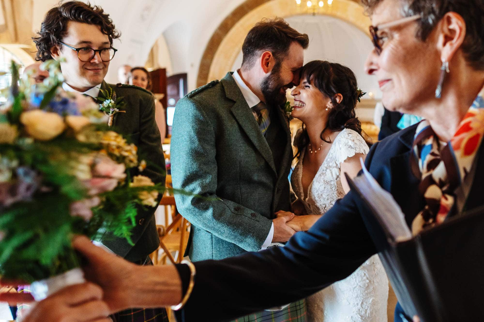 Celebrating love and commitment at a traditional wedding, featuring the bride and groom surrounded by family and friends.