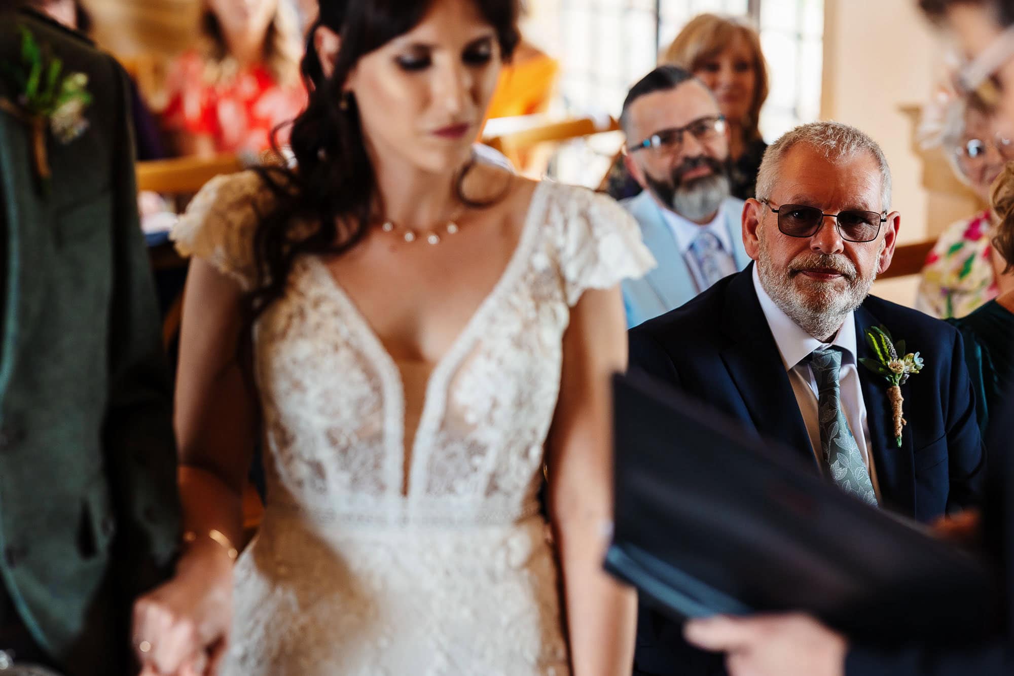 Bride and groom exchanging vows during a wedding ceremony at BGS Weddings, with guests witnessing the special moment in a beautifully decorated venue.