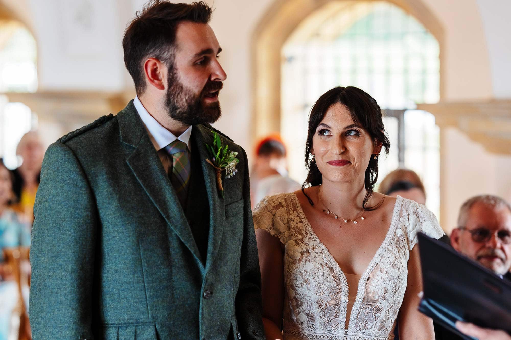 A bride and groom during their wedding ceremony at BGS Weddings, showcasing a romantic and elegant setting with beautiful architecture and joyful atmosphere.