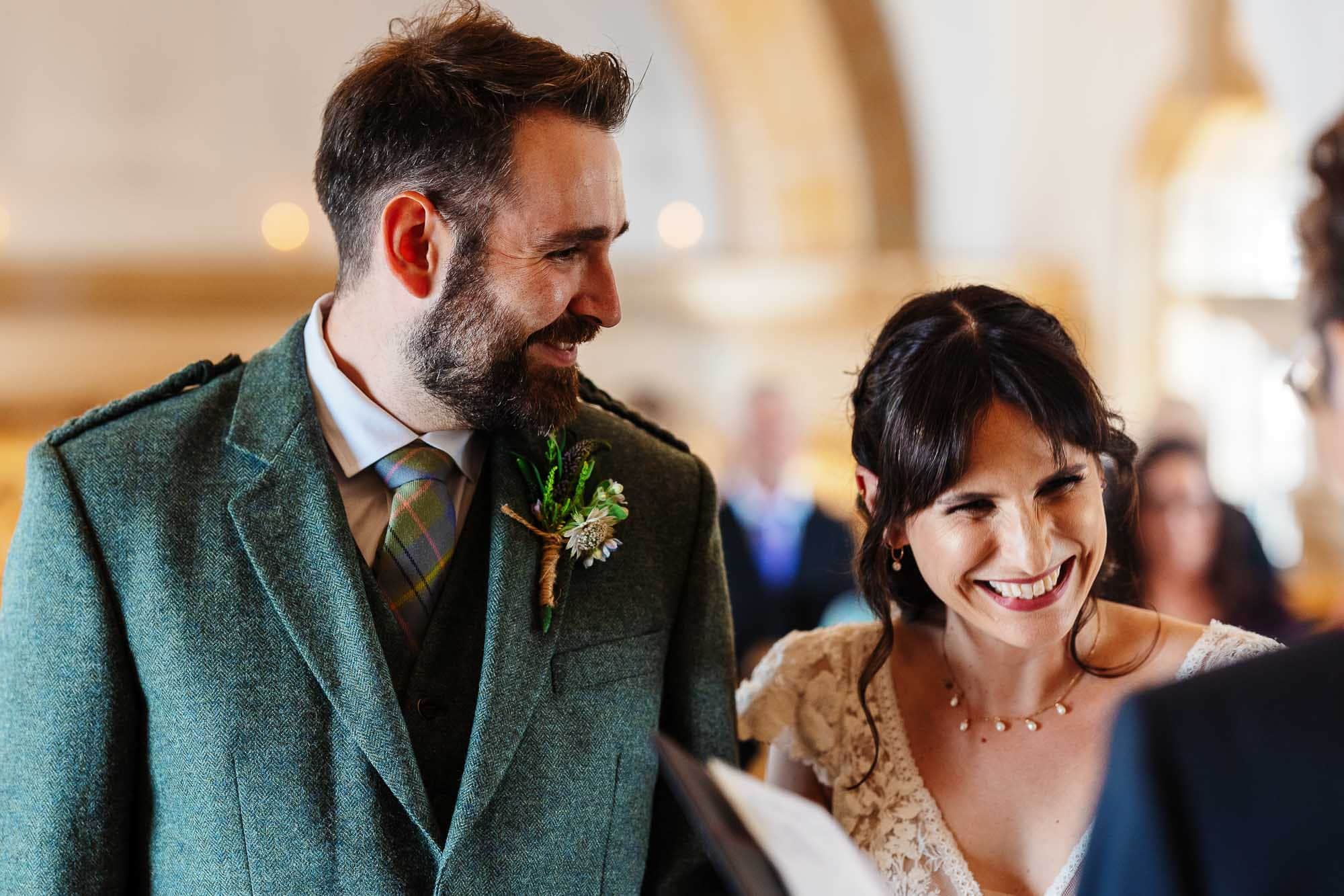 Wedding ceremony at BGS Weddings, happy couple exchanging vows with joyful expressions and elegant attire.