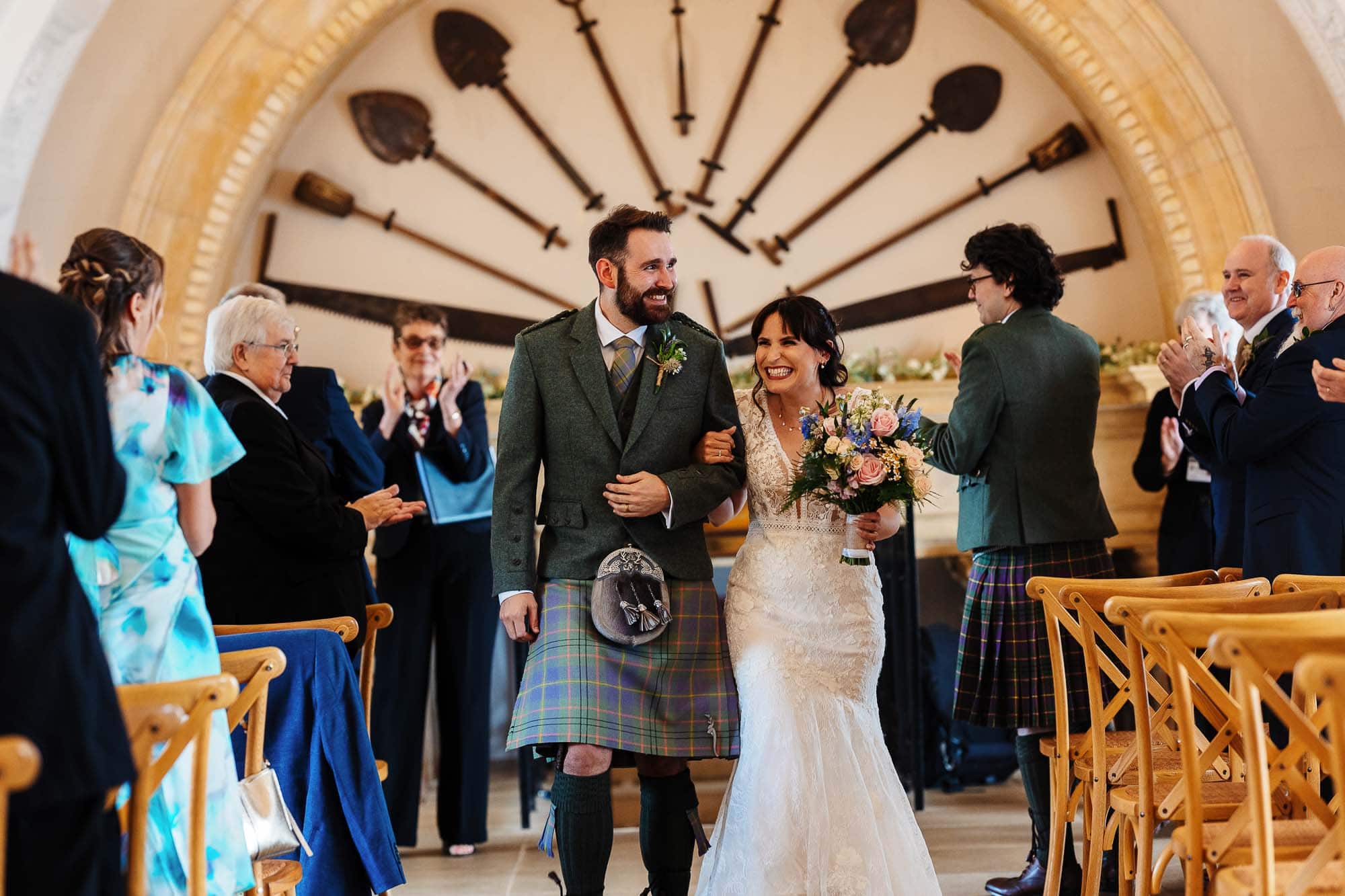 Elegant wedding ceremony featuring a bride and groom walking down the aisle surrounded by family and friends.